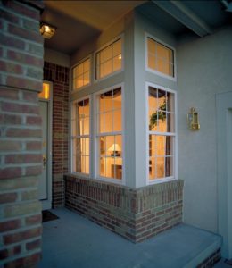 A corner transparent window having light coming out of it 